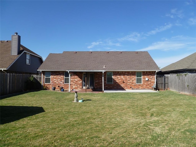 back of house featuring a lawn and a patio