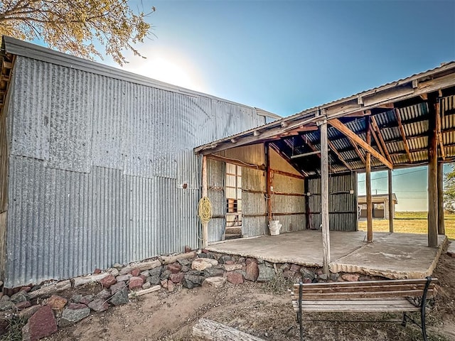 back house at dusk featuring an outdoor structure