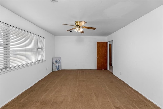 unfurnished room with carpet flooring and ceiling fan