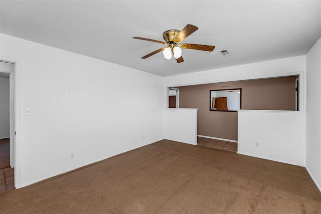 unfurnished room with ceiling fan and dark carpet