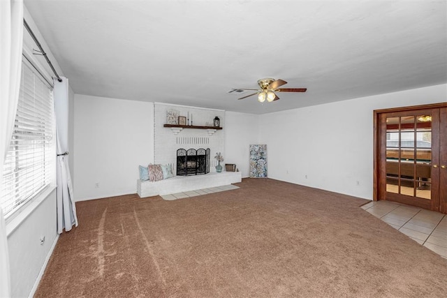 unfurnished living room featuring ceiling fan, light colored carpet, and a fireplace