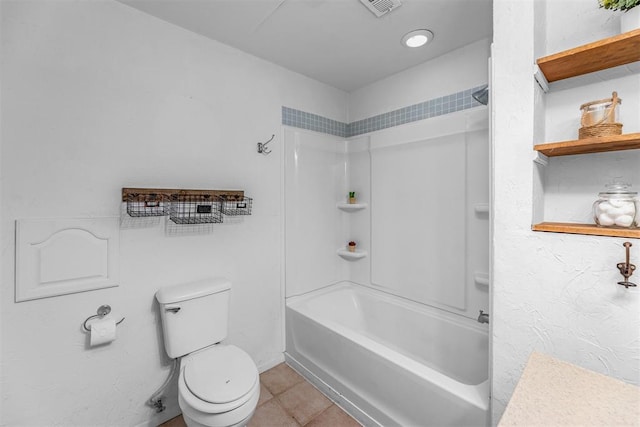 bathroom featuring bathing tub / shower combination, tile patterned flooring, and toilet