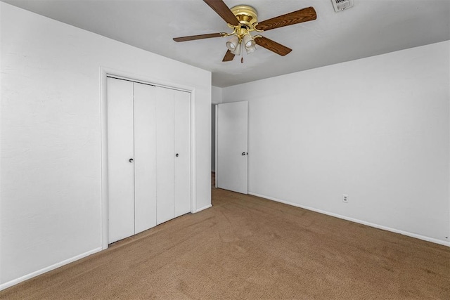 unfurnished bedroom with carpet, ceiling fan, and a closet