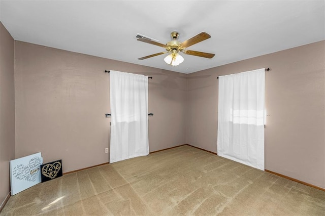 unfurnished room featuring light carpet and ceiling fan