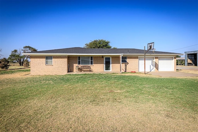 single story home featuring a garage, a front yard, brick siding, and driveway