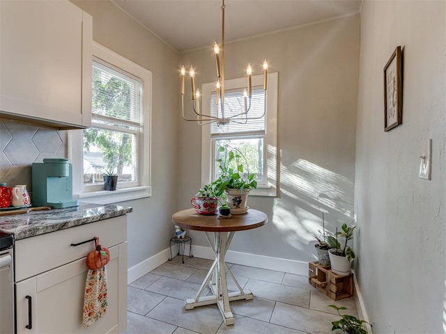 dining space with light tile patterned floors and a notable chandelier