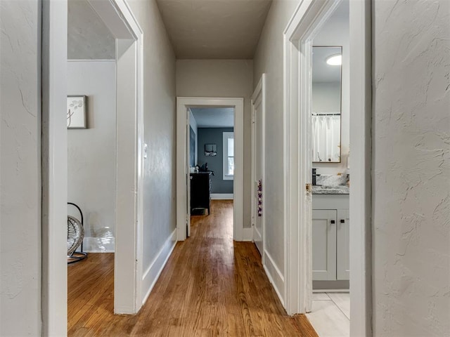 corridor with light wood-type flooring