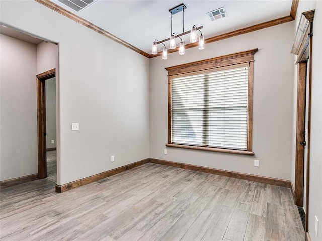 unfurnished dining area featuring light wood-type flooring and crown molding