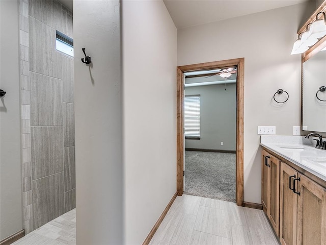 bathroom with ceiling fan and vanity