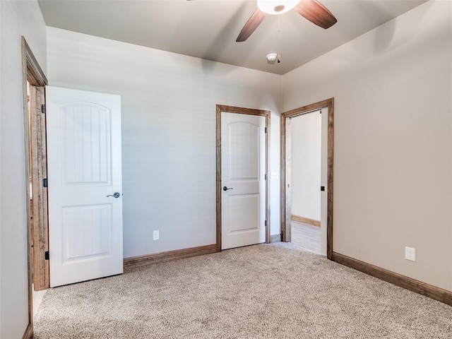 unfurnished bedroom featuring ceiling fan and light colored carpet