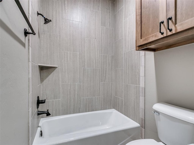 bathroom featuring toilet and tiled shower / bath