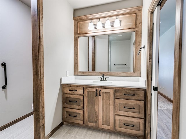 bathroom with hardwood / wood-style flooring and vanity