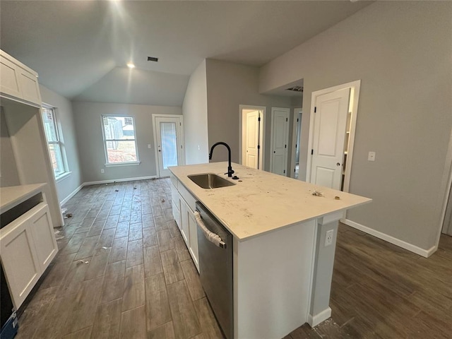 kitchen featuring a kitchen island with sink, sink, and white cabinets