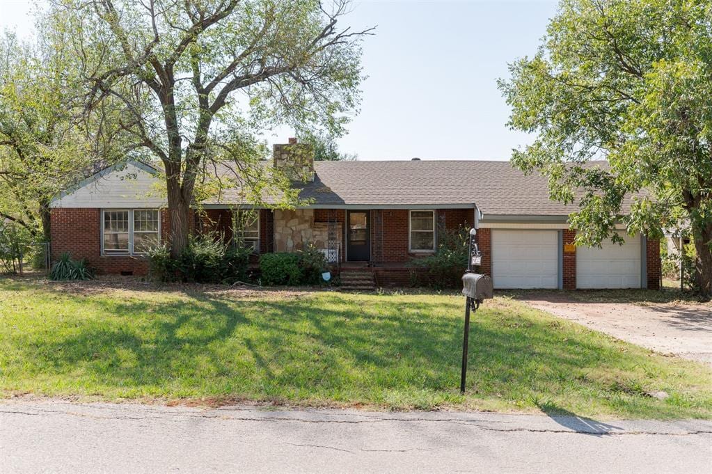 single story home with a front lawn and a garage