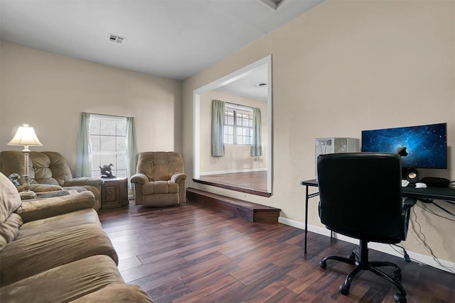 home office featuring plenty of natural light and dark hardwood / wood-style floors