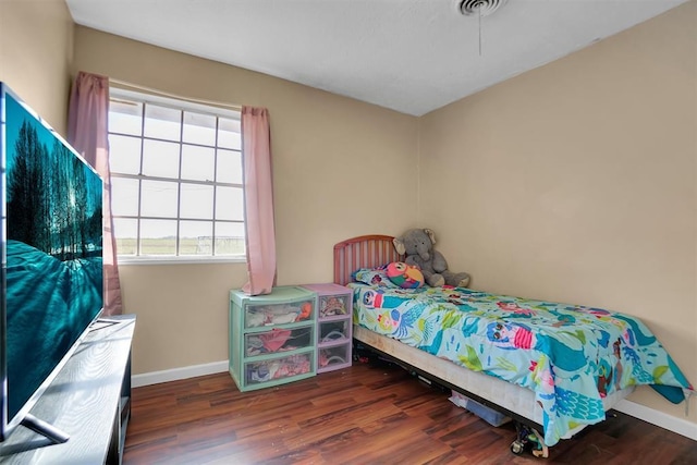 bedroom with dark wood-type flooring