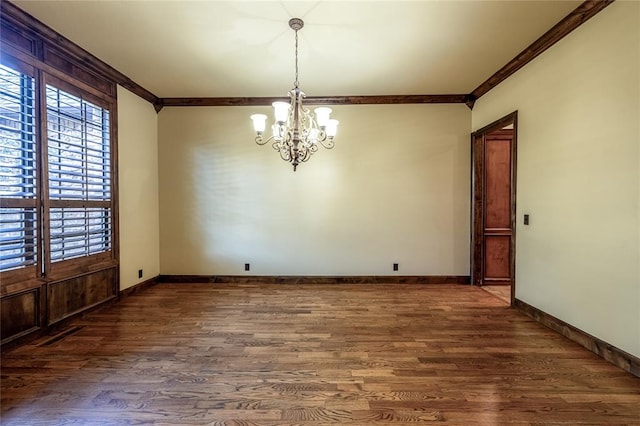 unfurnished dining area featuring a chandelier, dark hardwood / wood-style flooring, and crown molding