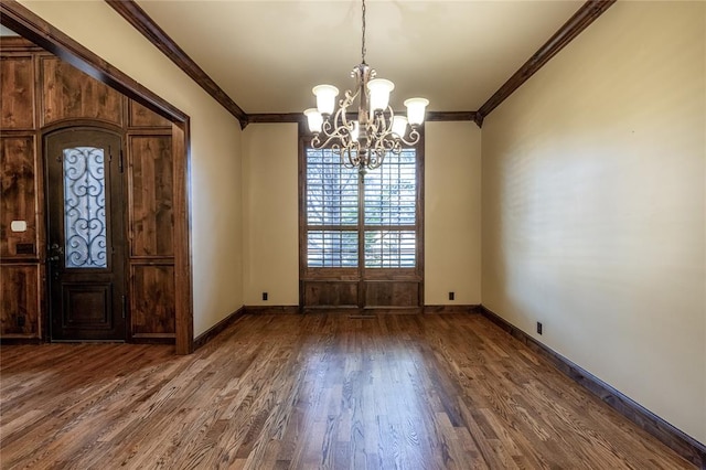 foyer with crown molding, a chandelier, and dark hardwood / wood-style floors