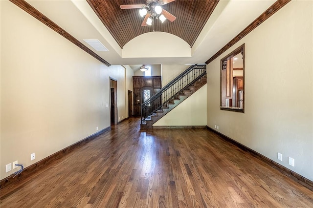 interior space featuring lofted ceiling, ceiling fan, crown molding, and dark hardwood / wood-style floors