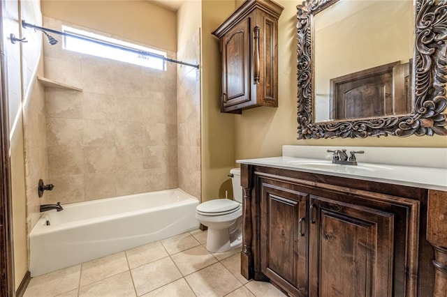 full bathroom with tile patterned floors, vanity, tiled shower / bath combo, and toilet