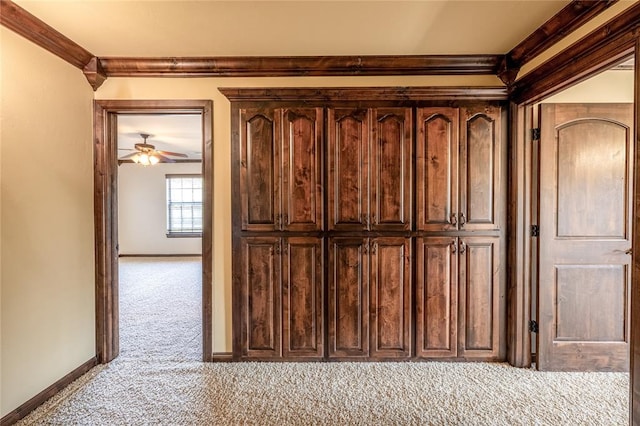 room details featuring carpet flooring, ceiling fan, and ornamental molding