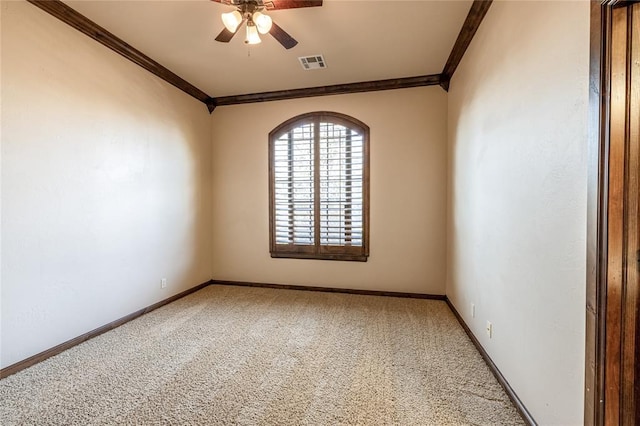 carpeted empty room featuring ceiling fan and ornamental molding