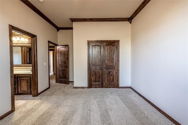 unfurnished bedroom with ornamental molding and light carpet