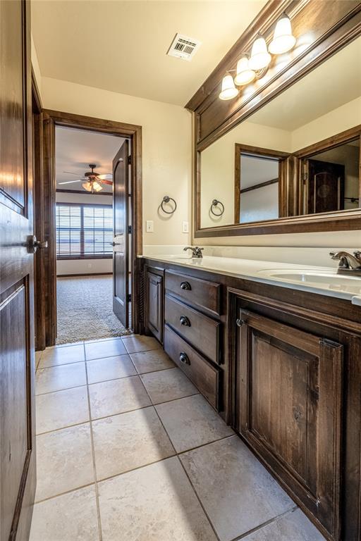 bathroom featuring tile patterned flooring, vanity, and ceiling fan