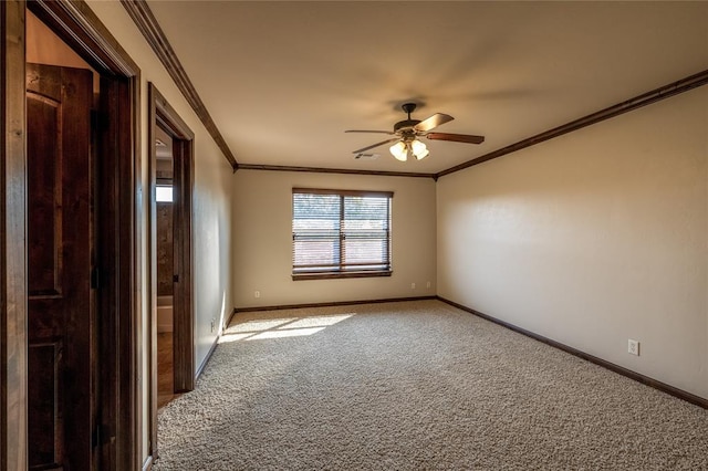 carpeted empty room with ceiling fan and crown molding