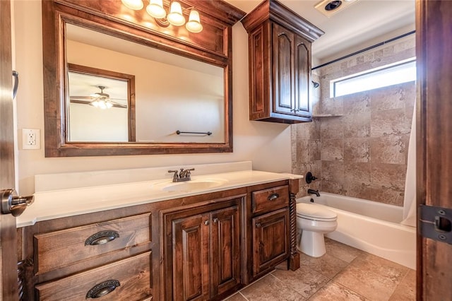 full bathroom featuring ceiling fan, toilet, vanity, and tiled shower / bath