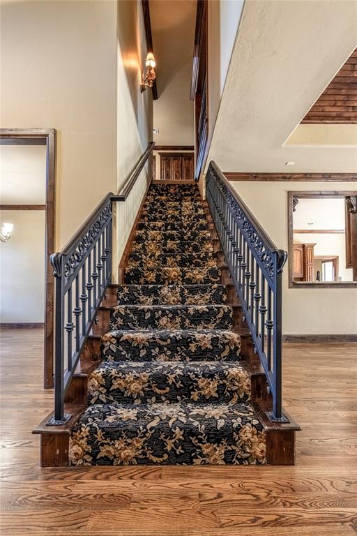 stairs with hardwood / wood-style flooring