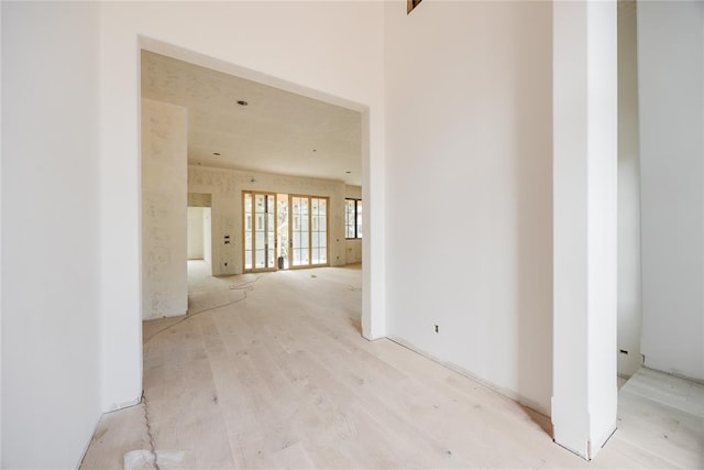 hallway with light hardwood / wood-style flooring