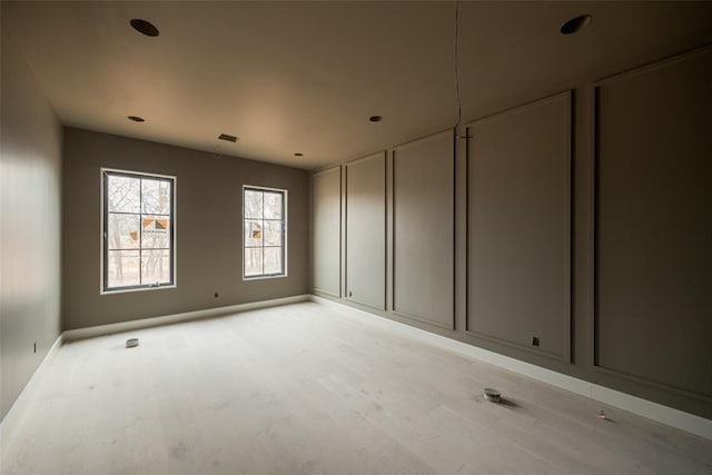 empty room with light hardwood / wood-style floors