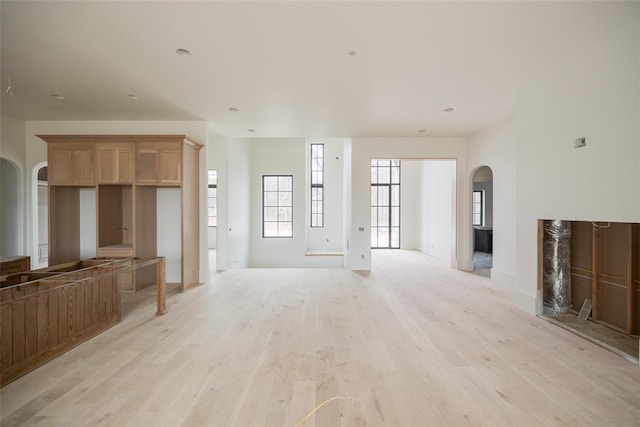 unfurnished living room with light wood-type flooring