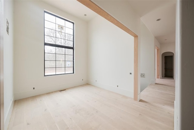 unfurnished room with light hardwood / wood-style flooring and a healthy amount of sunlight