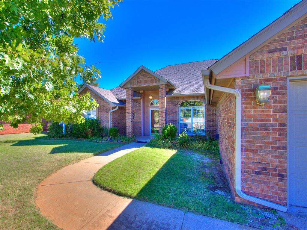 property entrance featuring a yard and a garage