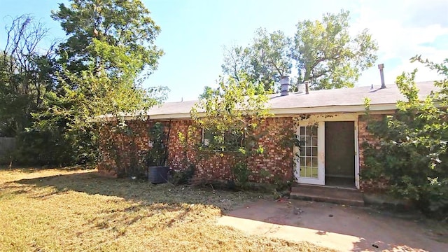 rear view of property with a patio area and a lawn