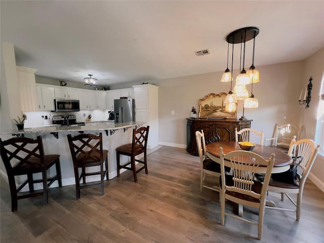 dining area featuring dark hardwood / wood-style flooring