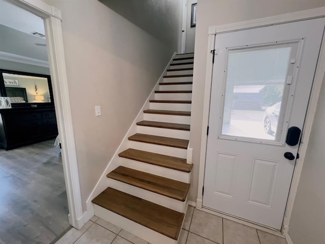 interior space featuring crown molding and tile patterned flooring