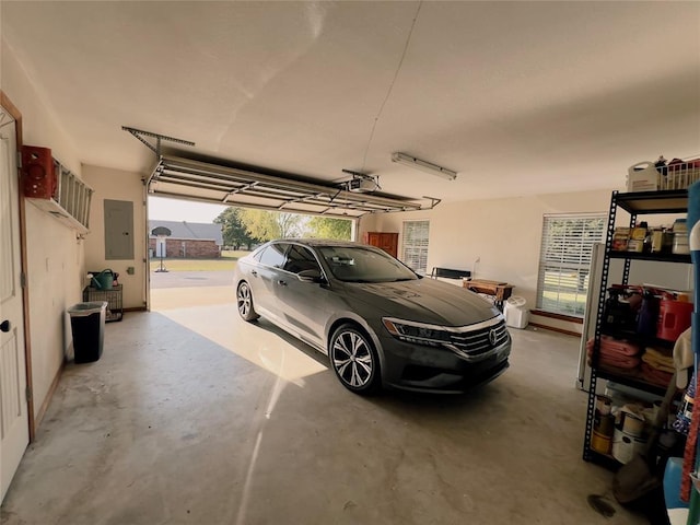 garage with electric panel and a garage door opener