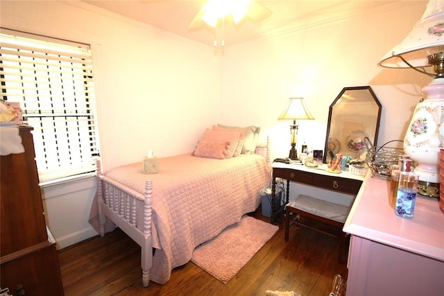 bedroom featuring dark hardwood / wood-style floors, ceiling fan, and ornamental molding