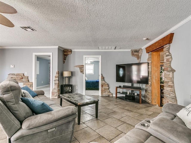 living room with a textured ceiling, ceiling fan, and crown molding