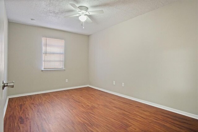 5825 NW 34th St, Oklahoma City, OK 73122 - empty room with a textured ceiling, wood finished floors, ceiling fan, and baseboards