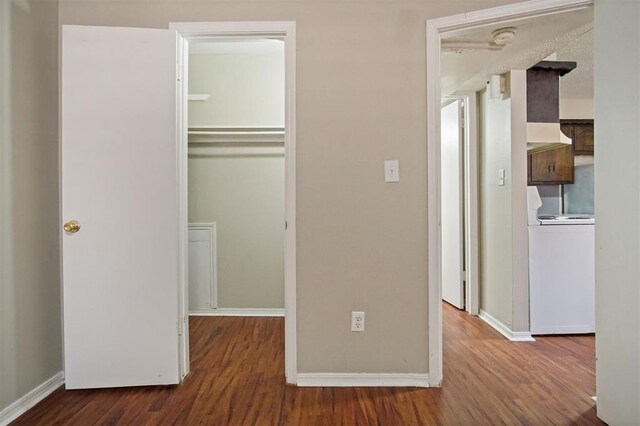 5825 NW 34th St, Oklahoma City, OK 73122 - unfurnished bedroom with wood finished floors, a closet, baseboards, and washer / clothes dryer