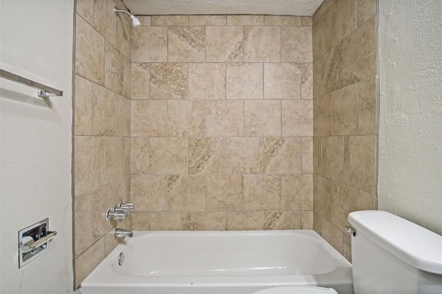 5825 NW 34th St, Oklahoma City, OK 73122 - bathroom featuring toilet, shower / bathtub combination, and a textured wall