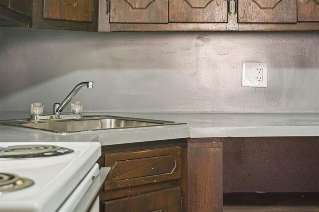 5825 NW 34th St, Oklahoma City, OK 73122 - kitchen featuring a sink, dark brown cabinets, and electric stove