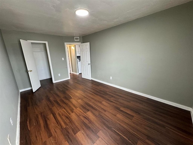 5825 NW 34th St, Oklahoma City, OK 73122 - unfurnished bedroom featuring dark wood-style flooring, baseboards, and a closet