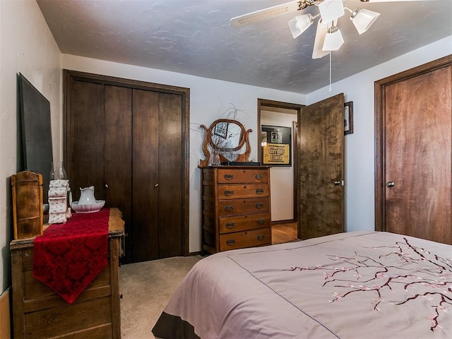 carpeted bedroom with a closet and ceiling fan