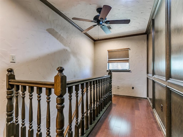 stairway featuring ceiling fan, ornamental molding, and hardwood / wood-style flooring