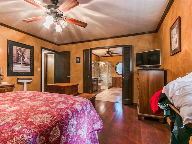 bedroom featuring ceiling fan, ensuite bathroom, wood-type flooring, and crown molding